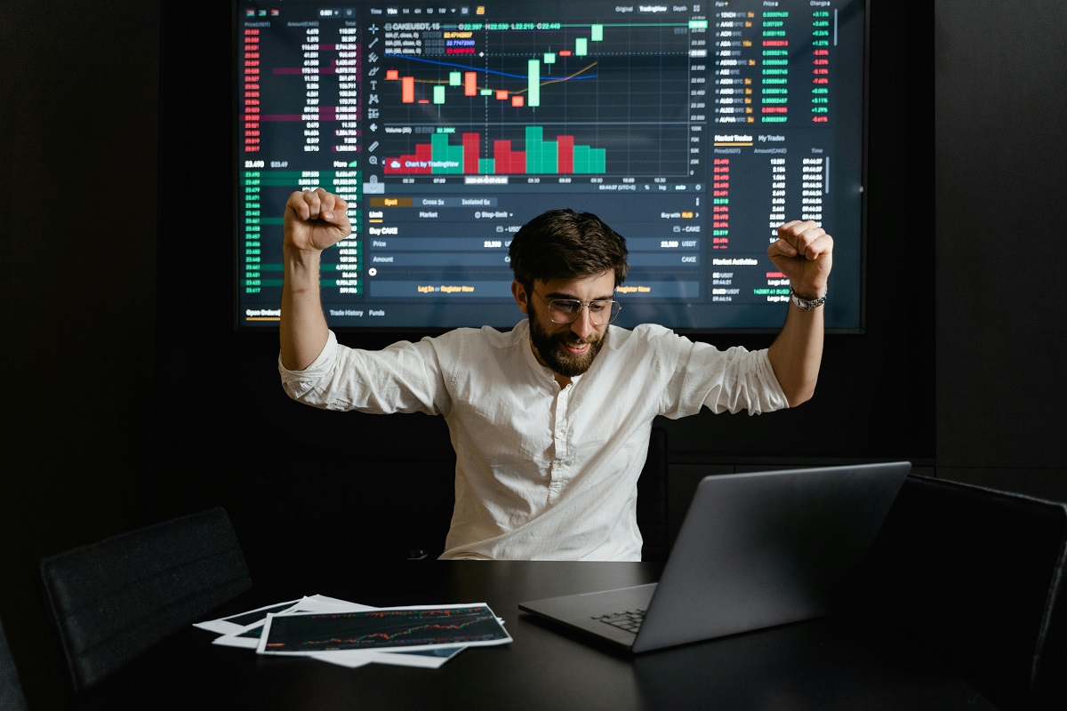 A businessman raising his hands for being successful