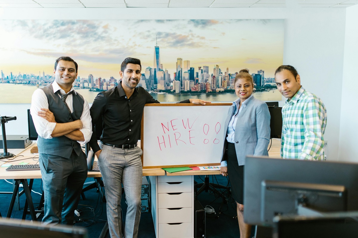 People Standing Beside White Board